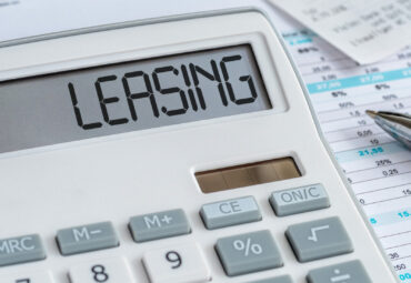 A calculator with the word Leasing on the display