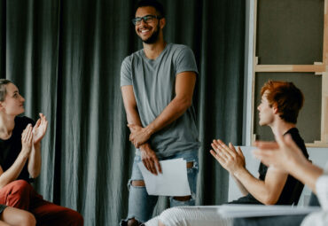 Young happy man after his self presentation on a group psychotherapy