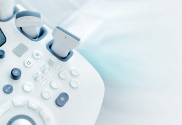 Modern medical equipment. An ultrasound machine and a couch. web banner