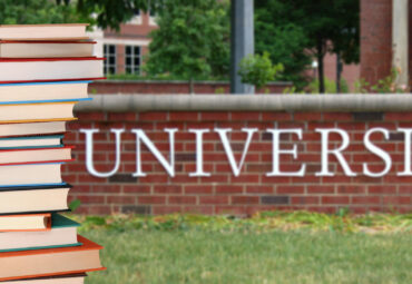 a pile of books in front of university