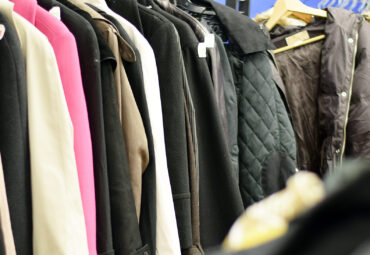 Racks of stylish used clothing at a thrift shop