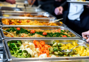 Cuisine Culinary Buffet Dinner Catering Dining Food Celebration Party Concept. Group of people in all you can eat catering buffet food indoor in luxury restaurant with meat and vegetables.