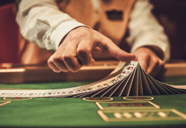 Croupier behind gambling table in a casino.