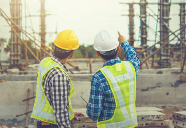 Two young man architect on a building construction site