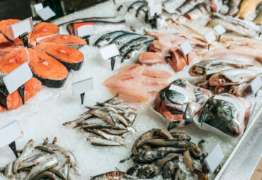 close up view of arranged raw seafood in supermarket