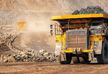 Open pit mine industry, big yellow mining truck for coal anthracite.