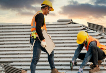 Asian engineer workers install new CPAC roof, roofing tools, electric drill, use on new roof with CPAC roof house construction idea.