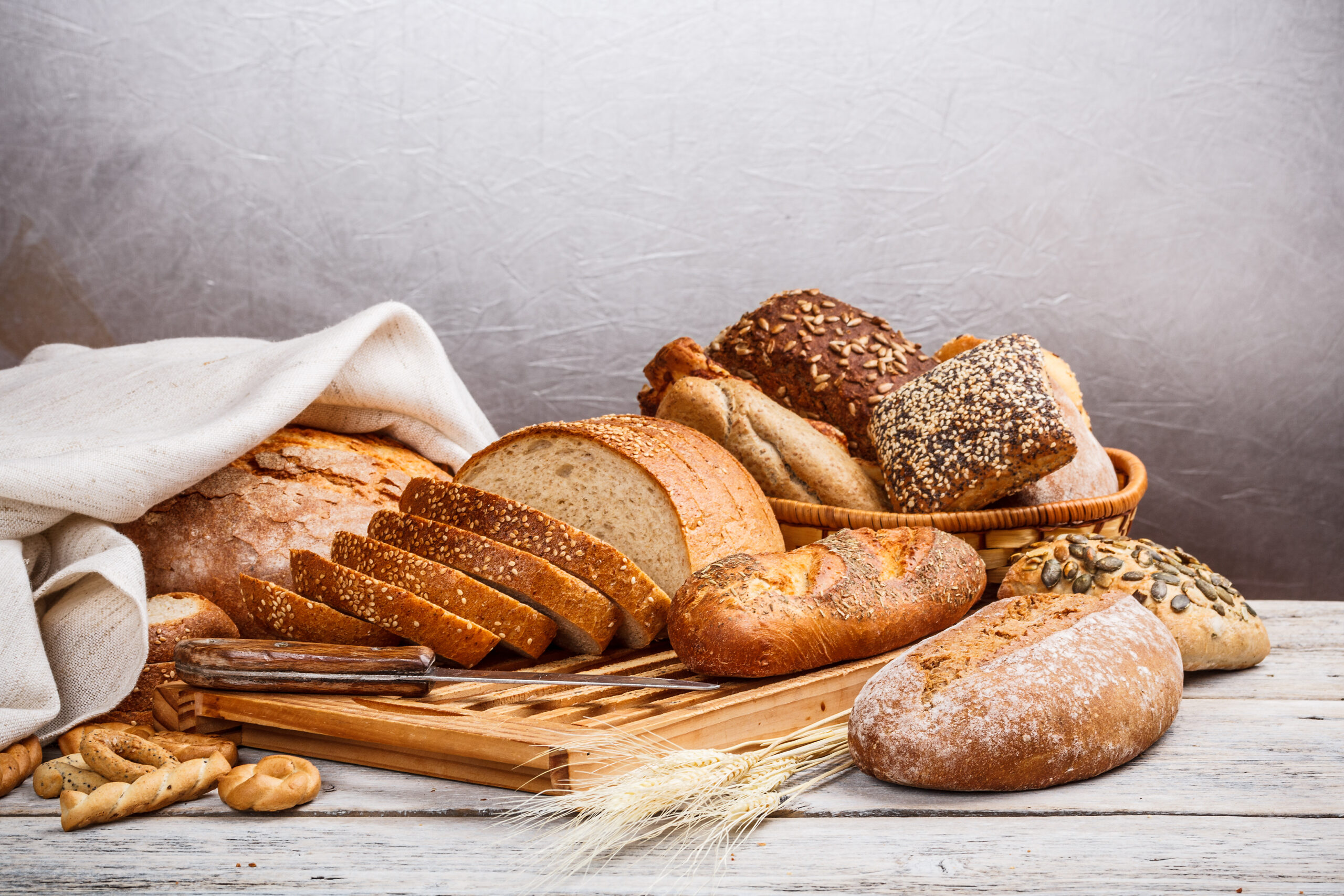 Collection of baked bread on wooden background